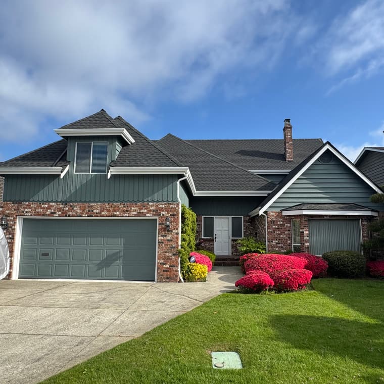 Exterior painting of a sage green rancher with brick accents