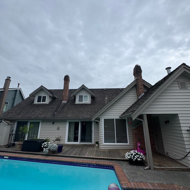 Home exterior repaint beside a backyard pool